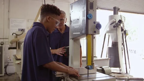 Carpenter And Male Apprentice Using Jigsaw  Stock Footage 72512512
