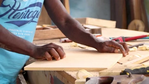 Carpenter applying sand paper on the edge of a wood. Carpenter working on wood. Stock Footage 223790995