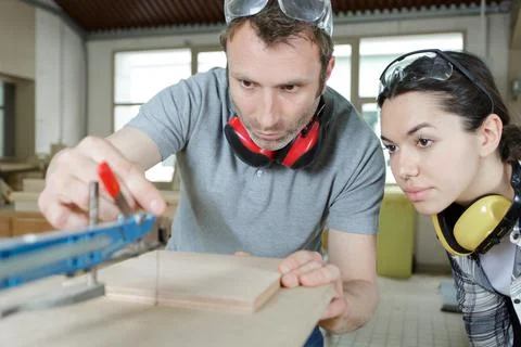 Carpenter with apprentice during training period Stock Photos