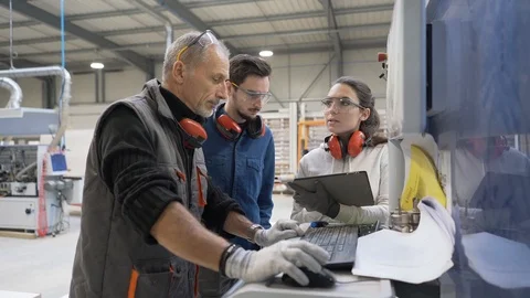 Carpenter with apprentice working in workshop Stock Footage 123162793