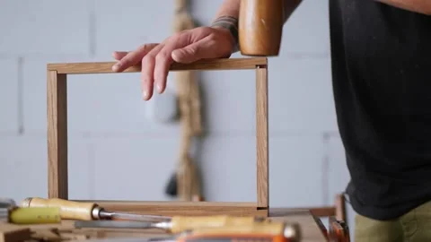 A carpenter assembles a wooden oak box to join it on a dovetail. the sounds o Vídeos de archivo 144244708
