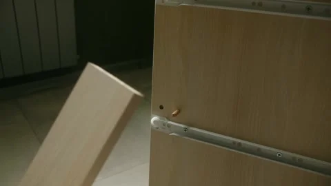Carpenter assembling furniture drawer using wooden dowel Stock-Footage 311941890