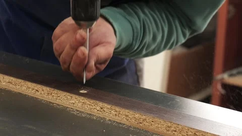 Carpenter assembling furniture with a power drill 库存影片 335464047