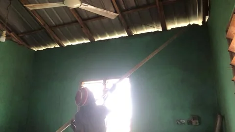 Carpenter Begins Ceiling Installation in Residential Room Stock Footage 319924128