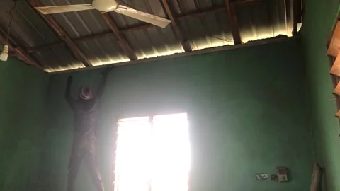 Carpenter Begins Ceiling Installation in Residential Room Stock Footage 319924246