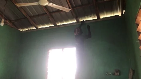 Carpenter Begins Ceiling Installation in Residential Room Stock Footage 319924509