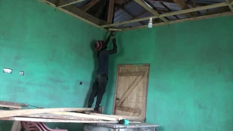 Carpenter Begins Ceiling Installation in Residential Room Stock Footage 319942593