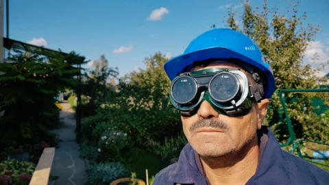 Carpenter in black flip up glasses Stock Footage 99019576