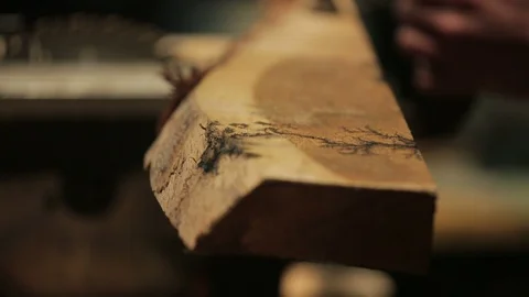 Carpenter blocks a piece of wood on the table saw with a clamp Stock-Footage 100984190