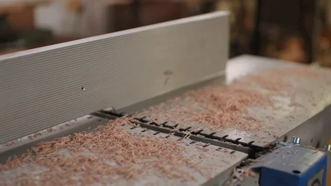 The carpenter blows sawdust with a compressor from the machine Stock Footage 126406699