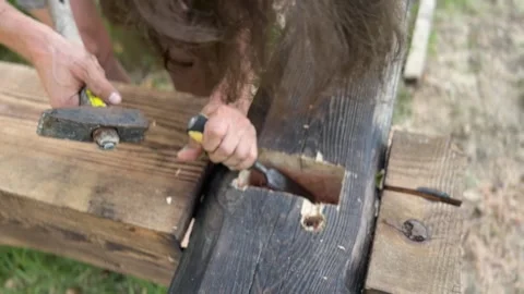 Carpenter build a wooden house with chisel and hummer. Stock Footage 283545147