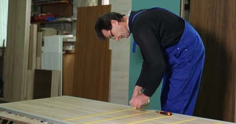 Carpenter Builder Man Work Expand a Scotch Tape on Furniture in Carpentry Shop Stock Footage 87943162