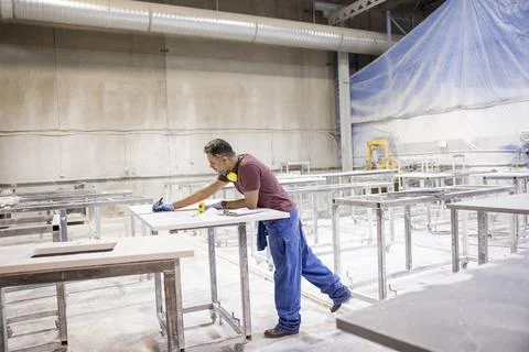 Carpenter building kitchen worktop in workshop Photos