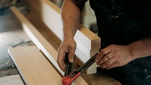 Carpenter in a carpentry workshop takes measurements Stock Footage 140675797