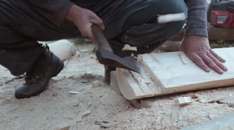 Carpenter carving timber using hand axe - closeup steadicam Stock Footage 57274668
