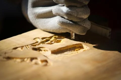 Carpenter carving wood with a chisel Stock Photos