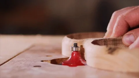 A carpenter is chamfers an edge from a compartmental dish on milling cutter Stock Footage 118064294