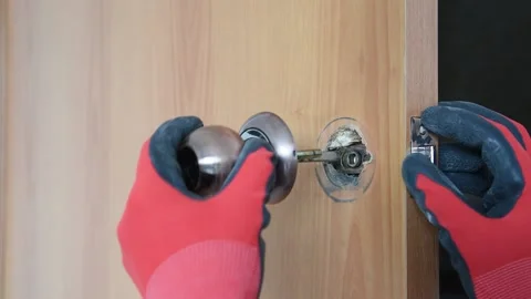 The carpenter changes the old door handle. Stock Footage 151136263