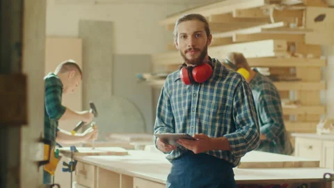 Carpenter in Checkered Shirt and Construction Noise Cancelling Headphones Stock Footage 236465828