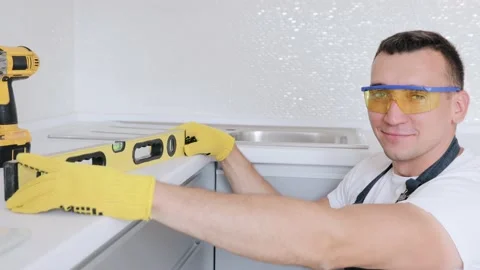 Carpenter is checking the accuracy of his woodwork by the spirit level Stock Footage 132693044