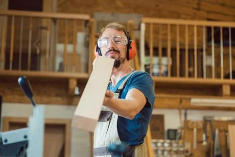 Carpenter checking his work Stock Photos