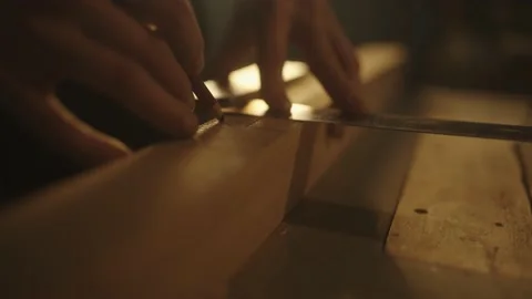 Carpenter checking wood plank's width for making a beautiful piece of furniture Stock Footage 148533948