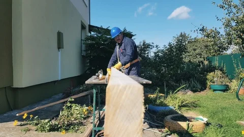 Carpenter checks level of board surface Stock Footage 99109957