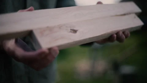 Carpenter checks size of two cross beams on hand made cross, slow motion Stock Footage 271198822