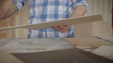 Carpenter chooses material for harvesting Stock Footage 153495408