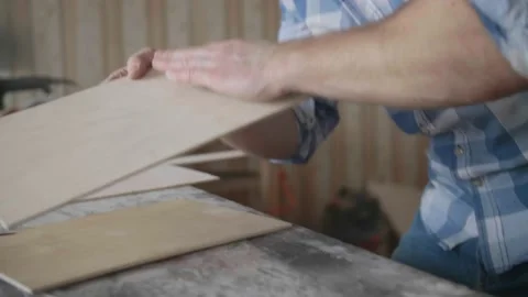Carpenter chooses material for harvesting Stock Footage 153495525