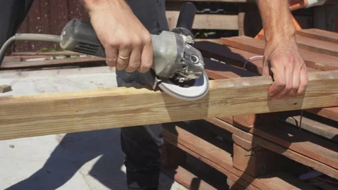 A carpenter cleans a tree with a grinder Stock Footage 314309255