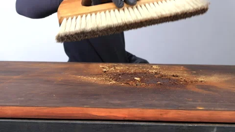 Carpenter clearing sawdust from work area Stock Footage 286042865