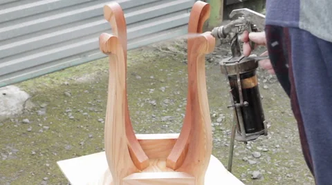 Carpenter is covering stool by lacquer Stock Footage 63319106
