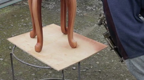 Carpenter is covering stool by lacquer Stock Footage 63319110