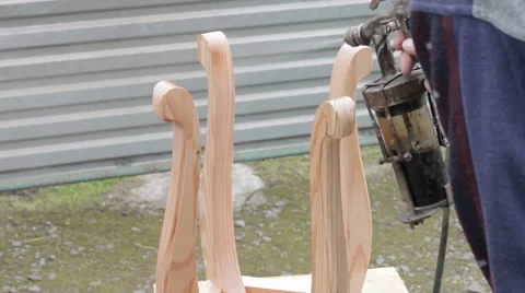 Carpenter is covering stool by lacquer Stock Footage 63319162