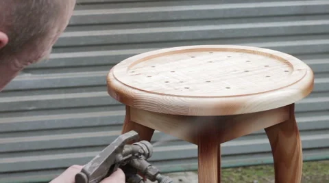 Carpenter is covering stool by lacquer Stock Footage 63319174