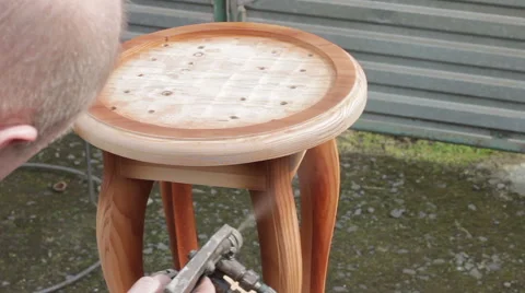 Carpenter is covering stool by lacquer Stock Footage 63319194