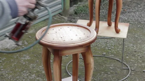 Carpenter is covering stool by lacquer Stock Footage 63319236