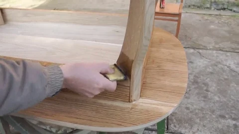 Carpenter is covering table by lacquer Stock Footage 69224397