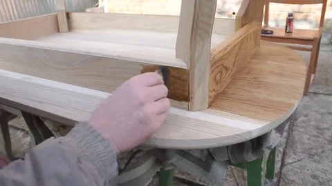 Carpenter is covering table by lacquer Stock Footage 69224677