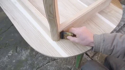 Carpenter is covering table by lacquer Stock Footage 69224712