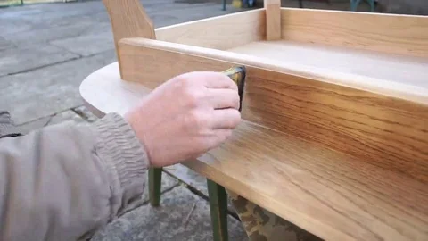 Carpenter is covering table by lacquer Stock Footage 69224759