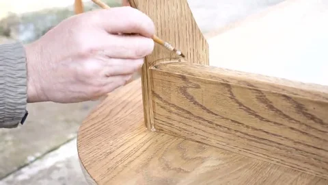 Carpenter is covering table by lacquer Stock Footage 69224997