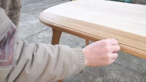 Carpenter is covering table by lacquer Stock Footage 69225184