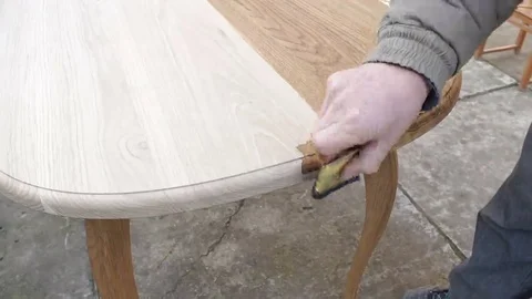 Carpenter is covering table by lacquer Stock Footage 69225425