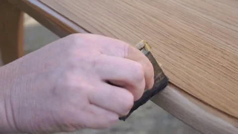 Carpenter is covering table by lacquer Stock Footage 69225455