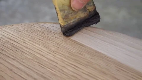 Carpenter is covering table by lacquer Stock Footage 69225503
