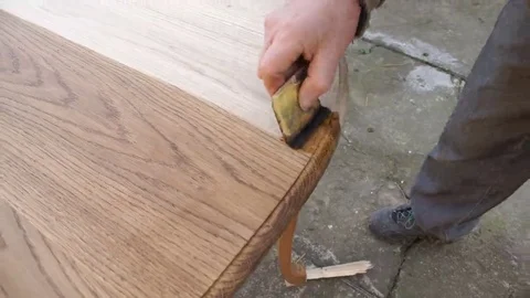 Carpenter is covering table by lacquer Stock Footage 69225535