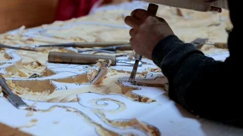 The carpenter creates a picture on a workbench, the hands of a wood carving Stock Footage 205611011