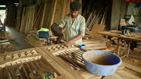 Carpenter creates small lumber blocks on hardwood panel 動画素材 313667157